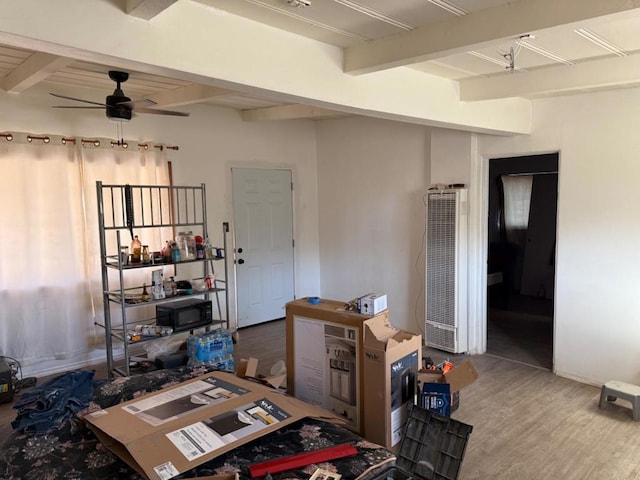 interior space with hardwood / wood-style floors, beam ceiling, and ceiling fan