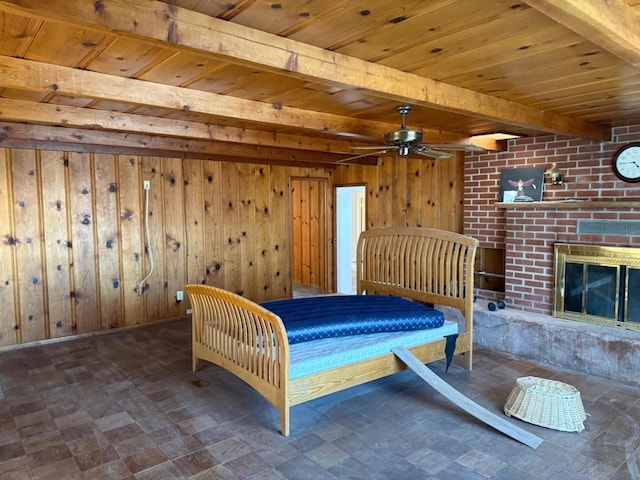 unfurnished bedroom with a brick fireplace, wooden walls, wooden ceiling, and beamed ceiling