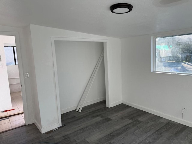 unfurnished bedroom featuring dark hardwood / wood-style floors and a closet