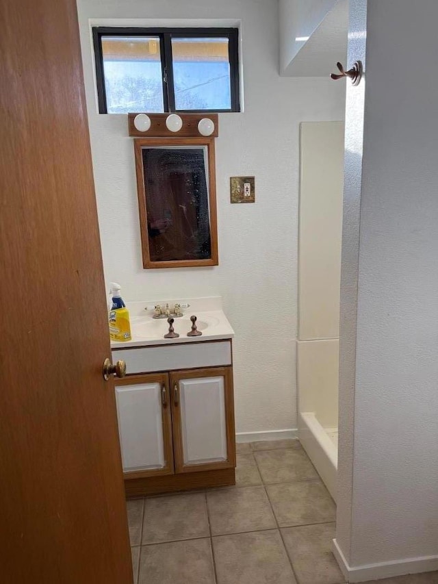 bathroom featuring a shower, tile patterned floors, and vanity