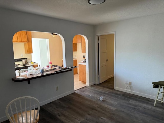 dining room with dark hardwood / wood-style floors and a textured ceiling