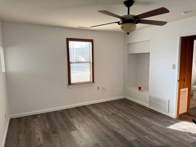 unfurnished bedroom featuring ceiling fan, dark hardwood / wood-style floors, a textured ceiling, and a closet