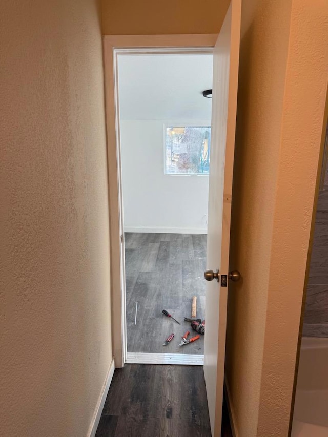 hallway with dark hardwood / wood-style floors