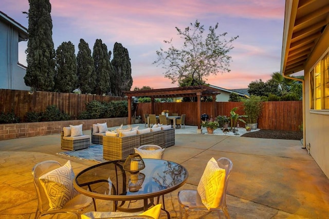 patio terrace at dusk featuring an outdoor hangout area