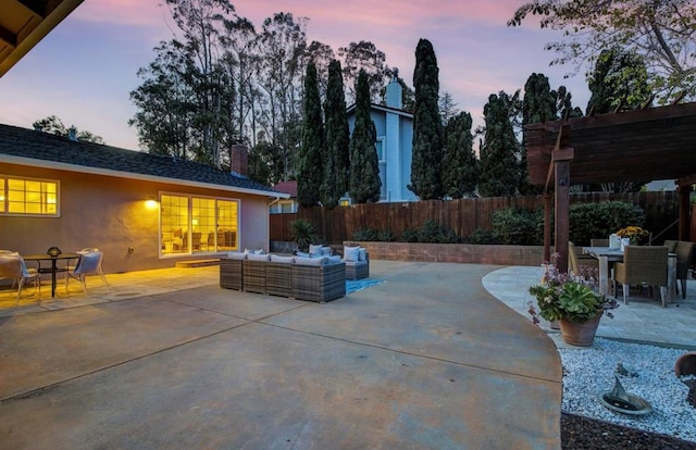 patio terrace at dusk featuring an outdoor hangout area