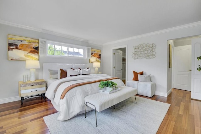 bedroom with crown molding and light hardwood / wood-style flooring