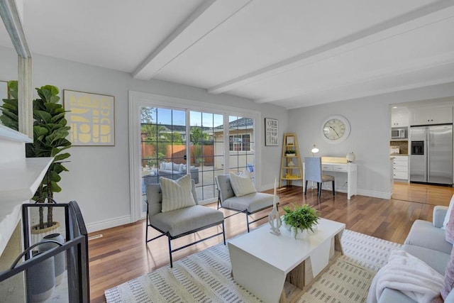 living room featuring beam ceiling and light wood-type flooring