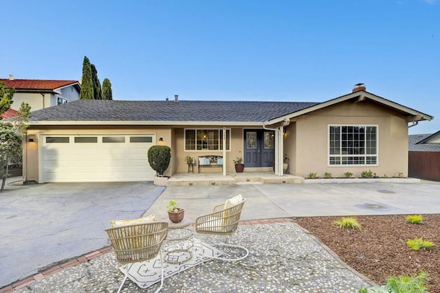 single story home with a garage and a porch