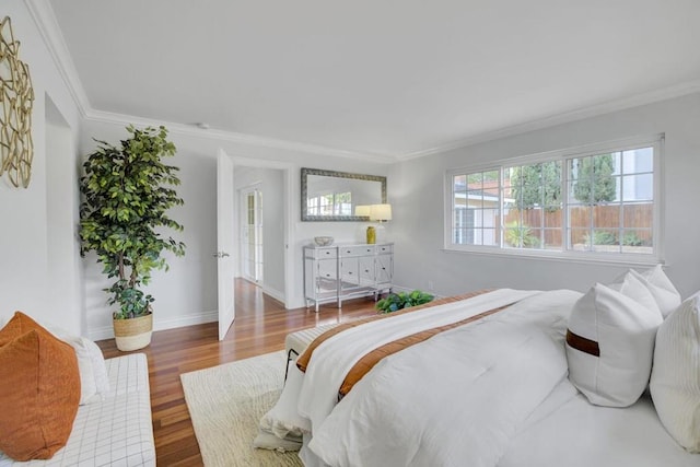 bedroom with wood-type flooring and ornamental molding