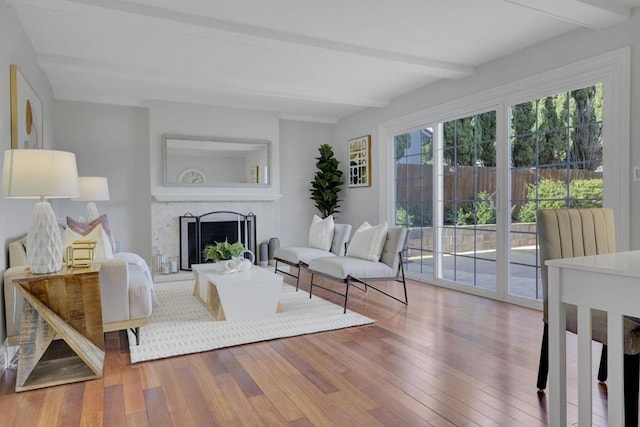 living room featuring wood-type flooring and beam ceiling