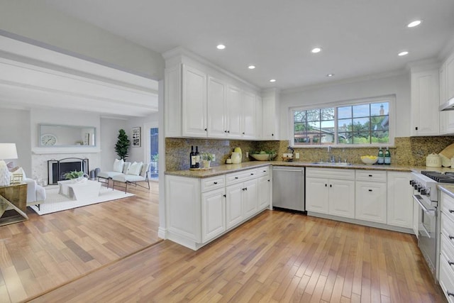 kitchen with white cabinetry, sink, light hardwood / wood-style flooring, and stainless steel appliances