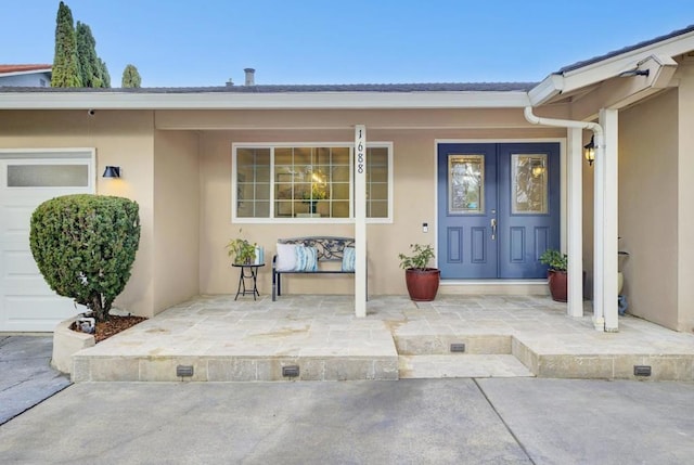 view of exterior entry with a garage