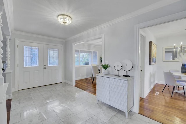 foyer entrance featuring ornamental molding and light hardwood / wood-style floors