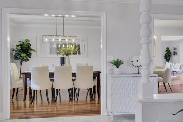 dining area with crown molding and light wood-type flooring