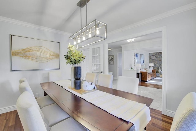 dining area featuring ornamental molding and dark hardwood / wood-style floors