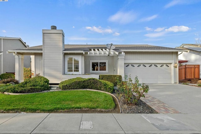 view of front of property featuring a garage and a front yard