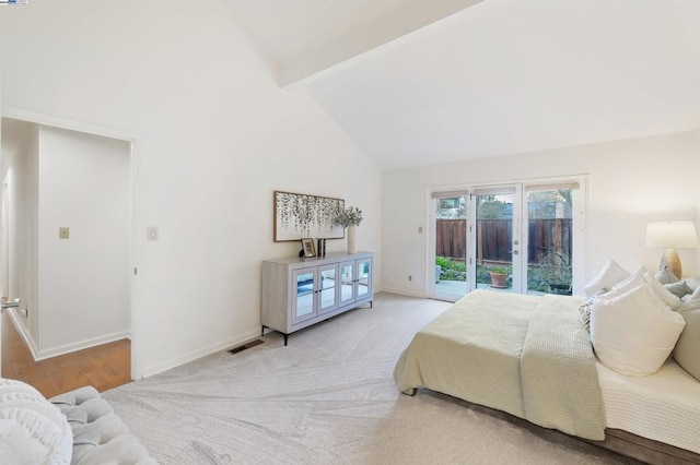 bedroom featuring beam ceiling, access to outside, high vaulted ceiling, and french doors