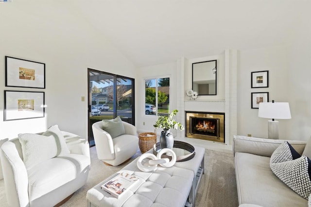 living room with a fireplace and high vaulted ceiling