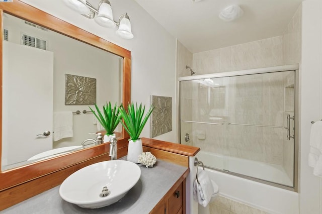 bathroom with vanity, tile patterned flooring, and enclosed tub / shower combo