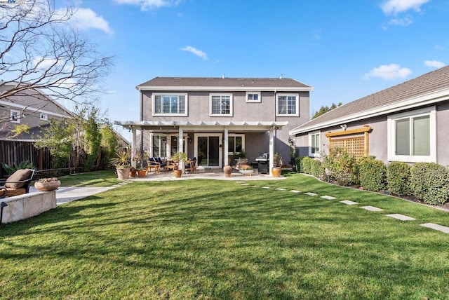 rear view of property with a pergola, a lawn, and a patio