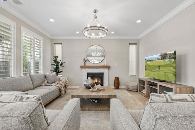 living room with ornamental molding and a chandelier