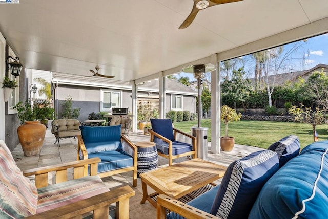 sunroom / solarium featuring a wealth of natural light and ceiling fan