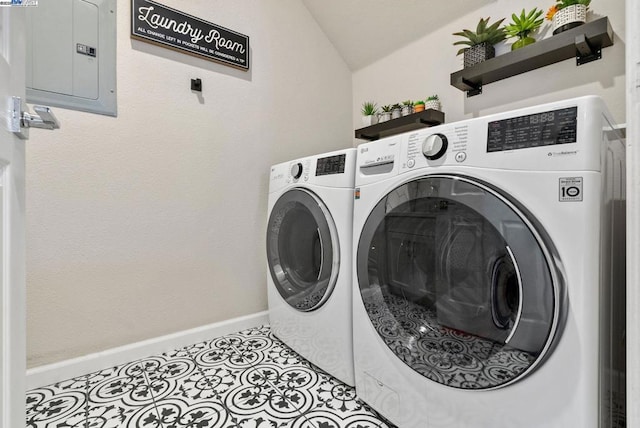 laundry room featuring light tile patterned flooring, electric panel, and washer and clothes dryer