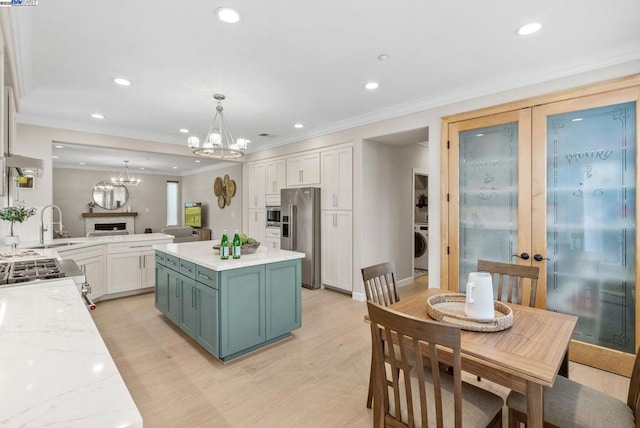 kitchen featuring french doors, light wood-type flooring, appliances with stainless steel finishes, pendant lighting, and white cabinets