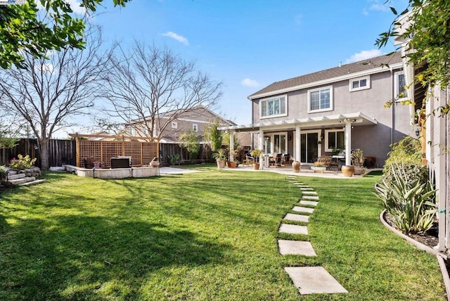 back of property featuring a pergola, a patio, and a lawn