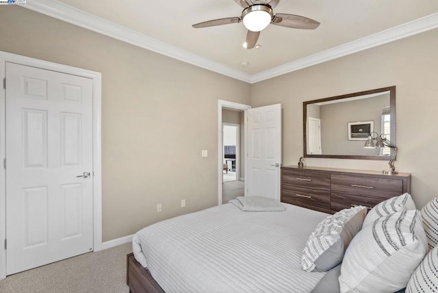 carpeted bedroom with crown molding and ceiling fan