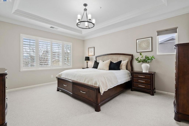 bedroom featuring crown molding, light colored carpet, a tray ceiling, and a chandelier