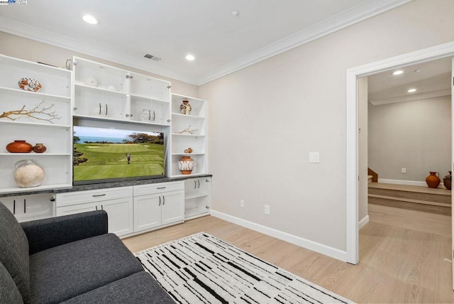 living room with crown molding and light hardwood / wood-style flooring