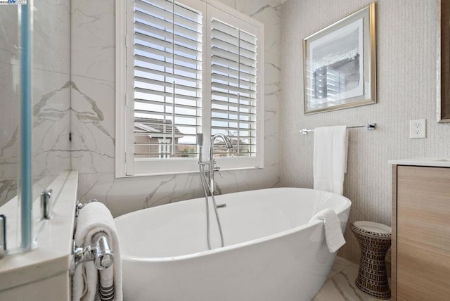 bathroom featuring vanity and a tub to relax in