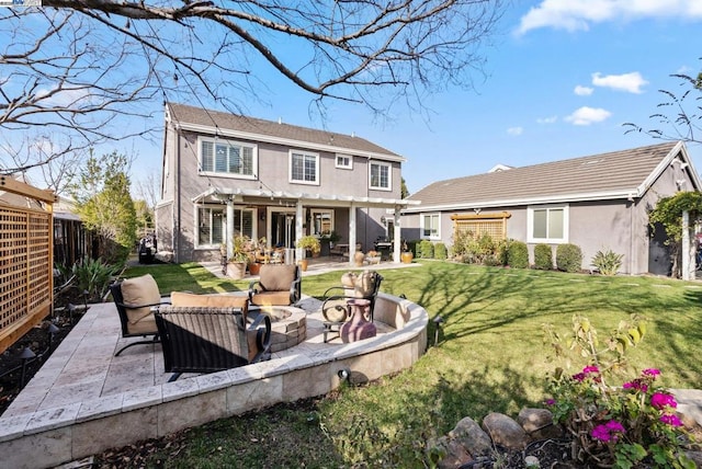 rear view of property featuring a yard, a pergola, a patio area, and an outdoor living space with a fire pit