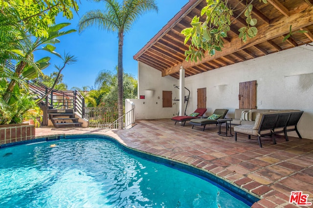 view of swimming pool with a patio area