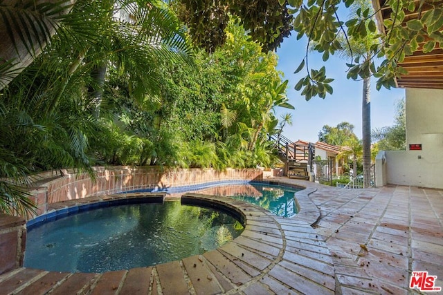 view of pool featuring an in ground hot tub and a patio area