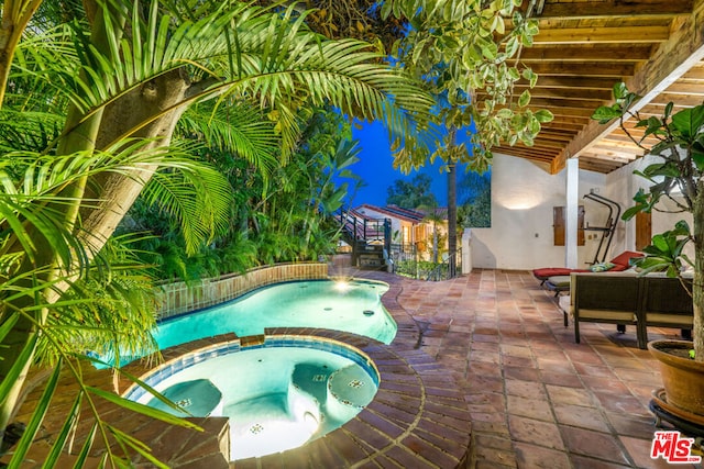 view of swimming pool with an in ground hot tub and a patio area