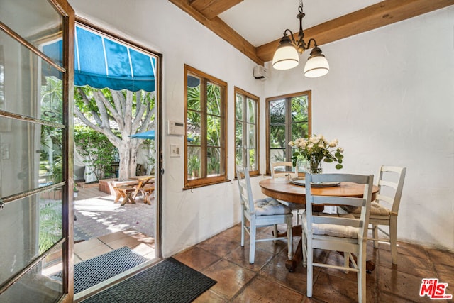 dining area with an inviting chandelier and beam ceiling