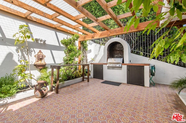 view of patio featuring area for grilling, a pergola, and exterior kitchen