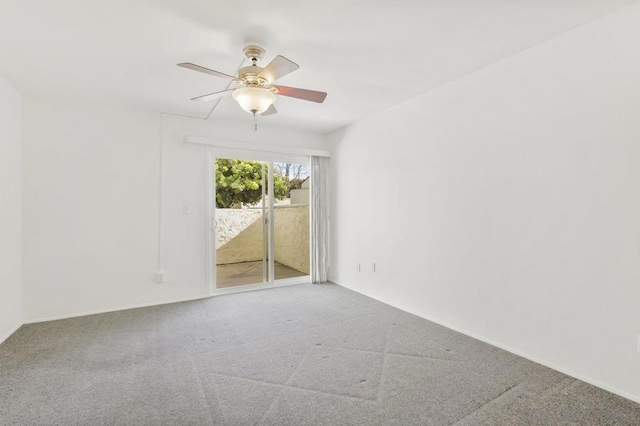 unfurnished room featuring ceiling fan and carpet floors