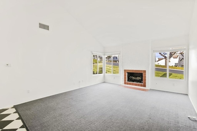 unfurnished living room with high vaulted ceiling, a fireplace, and carpet floors