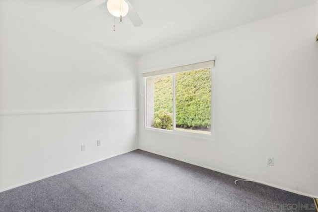 unfurnished room with ceiling fan and carpet flooring