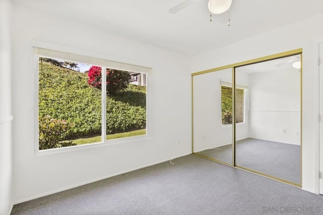 unfurnished bedroom featuring a closet, ceiling fan, and carpet