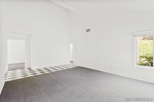 carpeted spare room with high vaulted ceiling and beamed ceiling