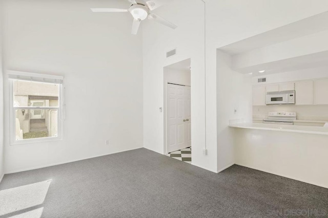 unfurnished living room featuring high vaulted ceiling, ceiling fan, and carpet