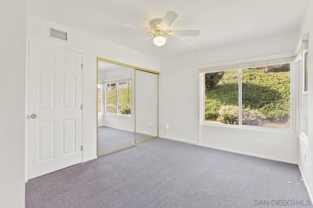 unfurnished bedroom with a closet, ceiling fan, and carpet