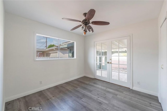 unfurnished room featuring hardwood / wood-style flooring, ceiling fan, and french doors