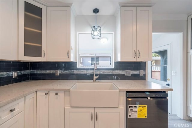 kitchen with white cabinets, sink, and dishwashing machine