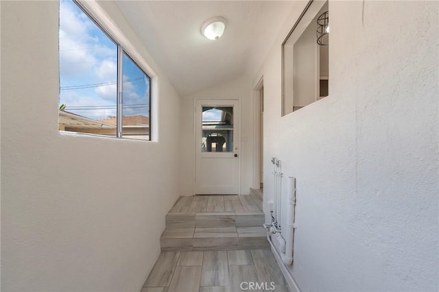 corridor with vaulted ceiling