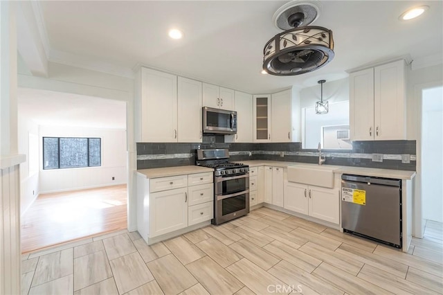 kitchen featuring stainless steel appliances, sink, and white cabinets